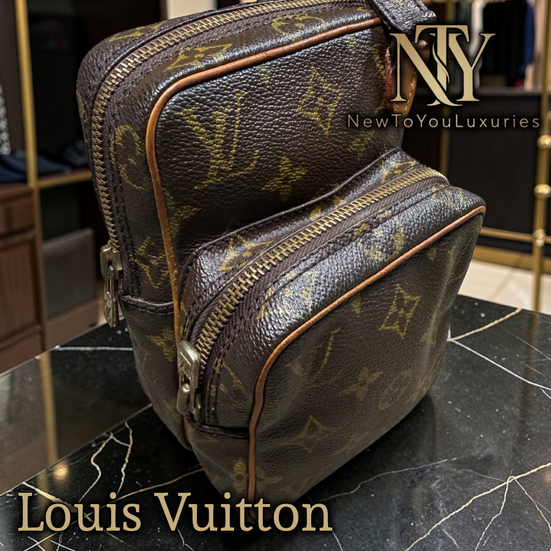 Pre-loved Louis Vuitton monogram bag on a black marble surface