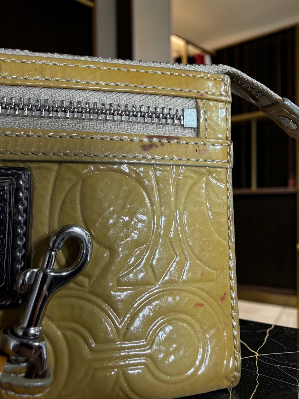 Grand porte-monnaie de poignet Coach Poppy en cuir verni jaune moutarde avec motif « C » embossé
