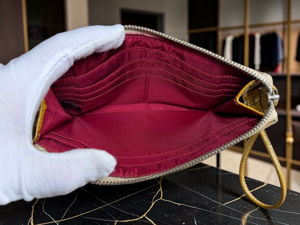 Grand porte-monnaie de poignet Coach Poppy en cuir verni jaune moutarde avec motif « C » embossé