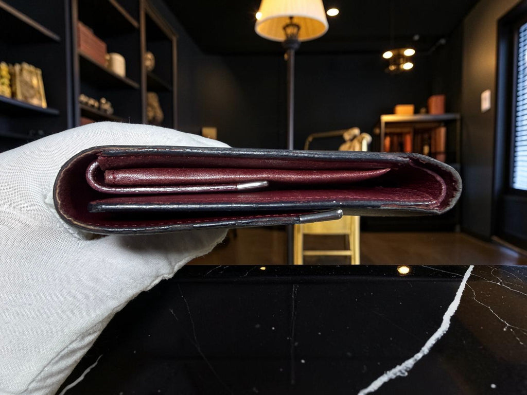 Cartier Cabochon Leather International Flap Wallet (Black with Red Interior).