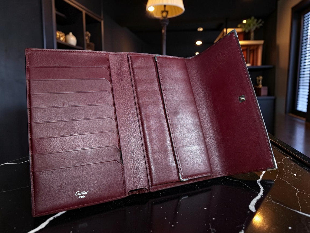 Cartier Cabochon Leather International Flap Wallet (Black with Red Interior).
