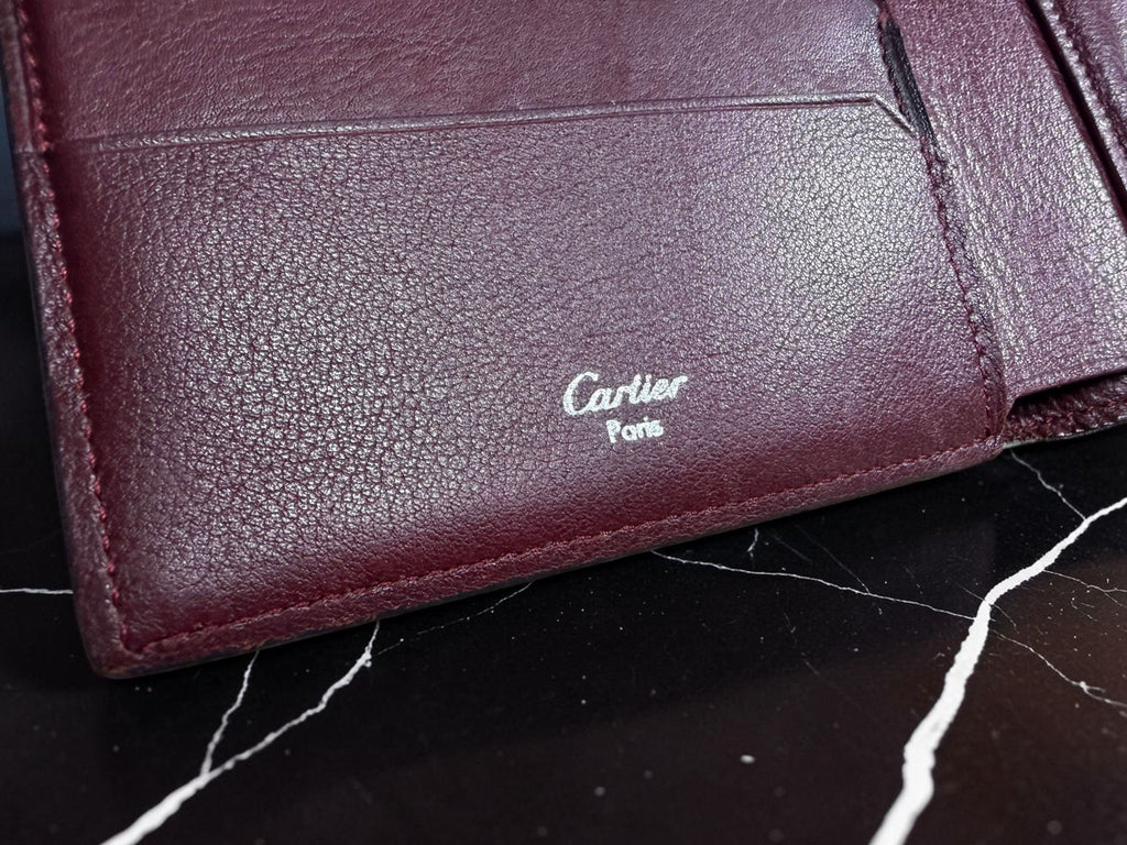 Cartier Cabochon Leather International Flap Wallet (Black with Red Interior).