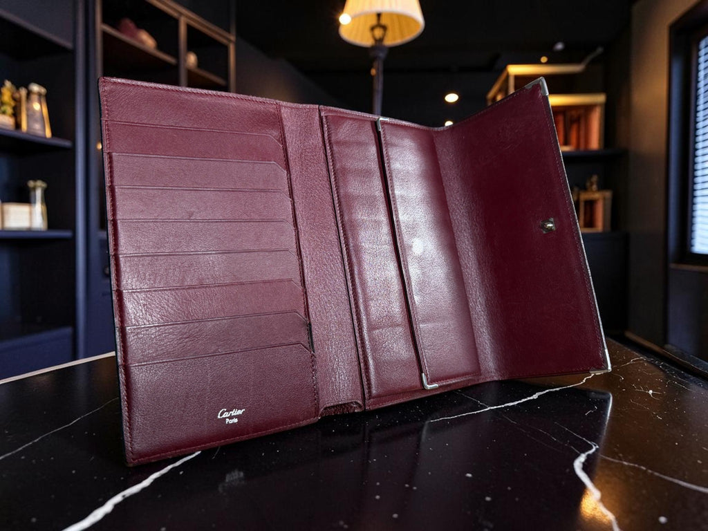 Cartier Cabochon Leather International Flap Wallet (Black with Red Interior).