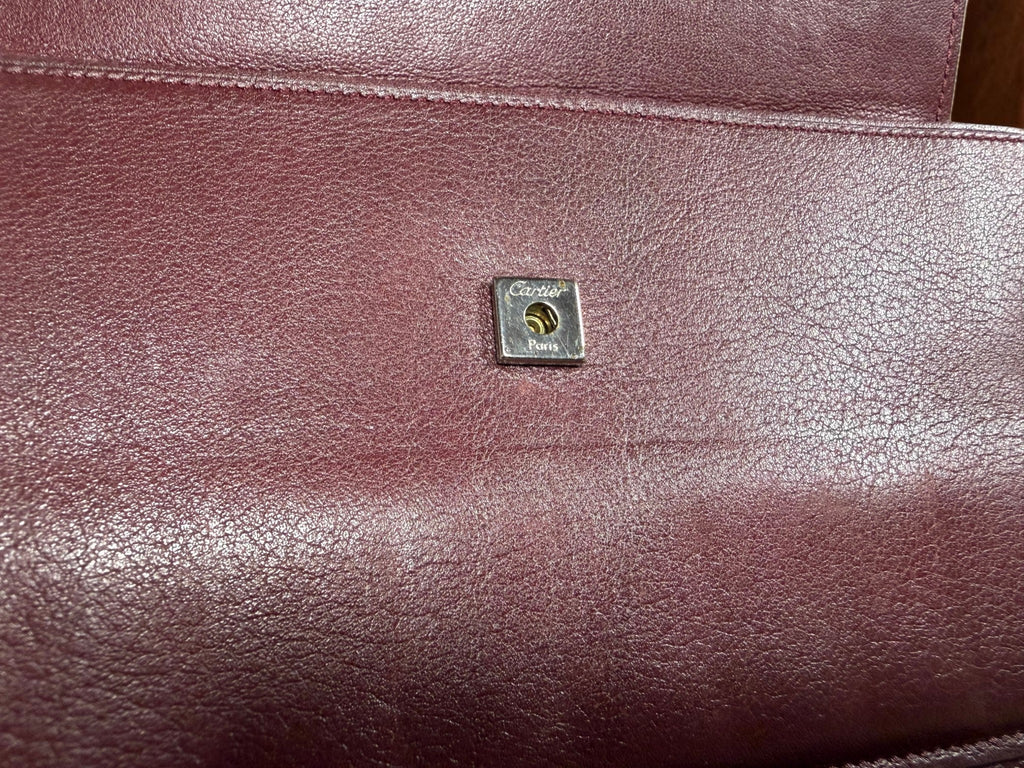 Cartier Cabochon Leather International Flap Wallet (Black with Red Interior).