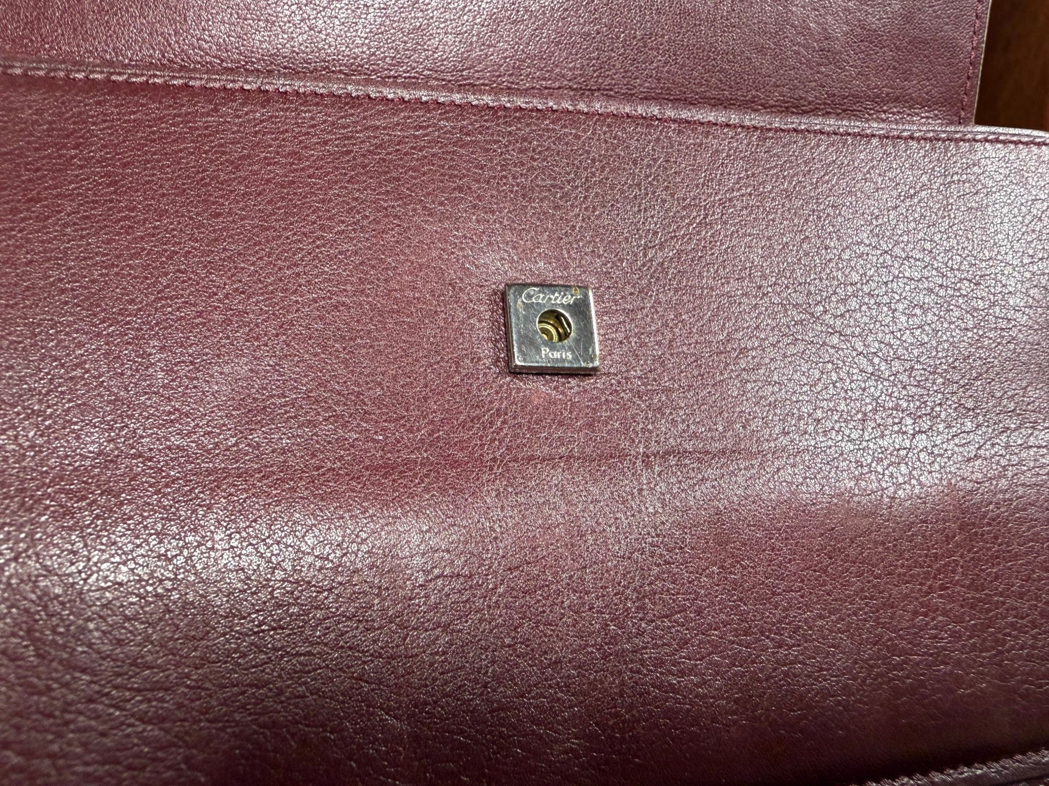 Cartier Cabochon Leather International Flap Wallet (Black with Red Interior).
