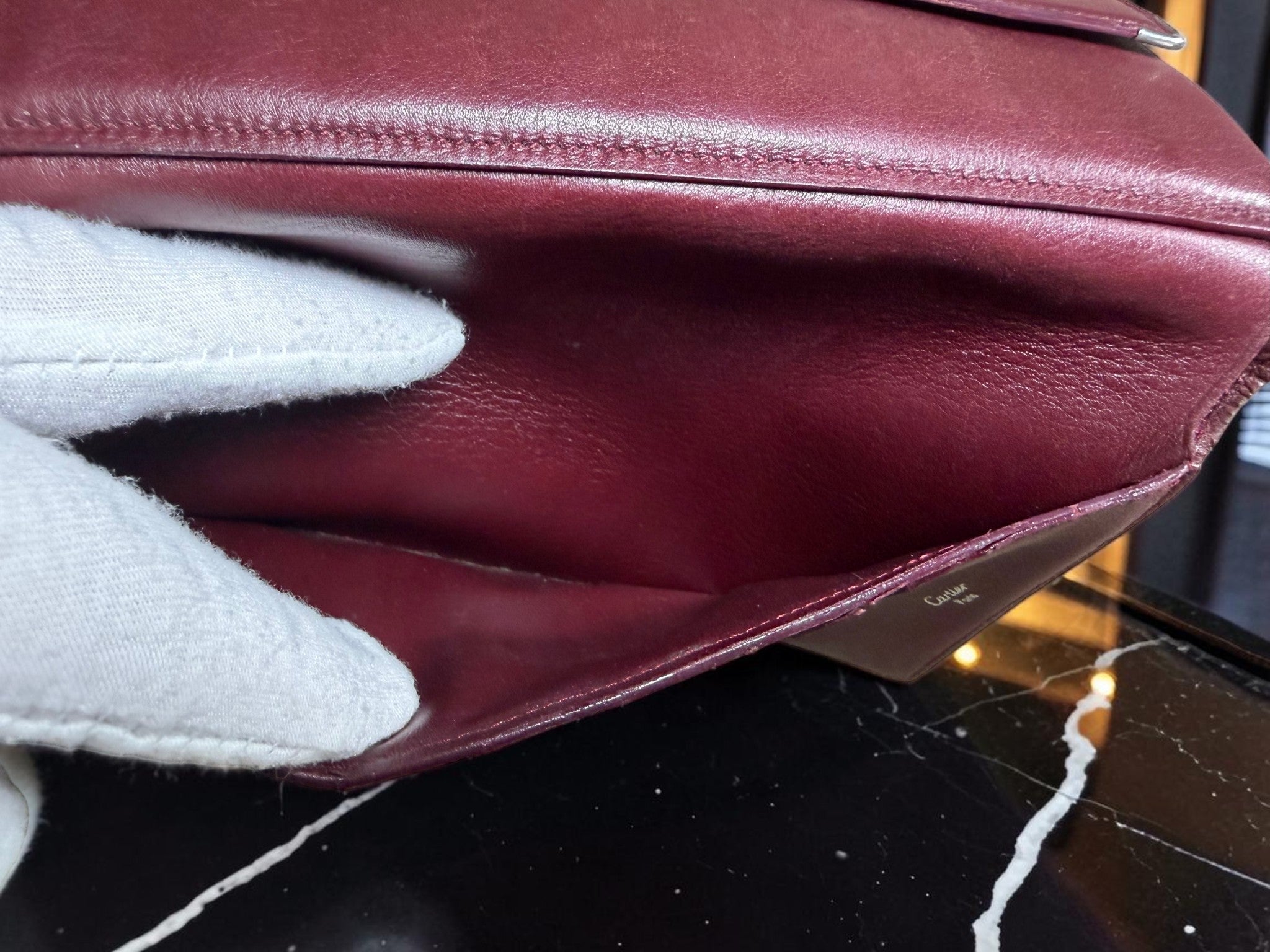 Cartier Cabochon Leather International Flap Wallet (Black with Red Interior).