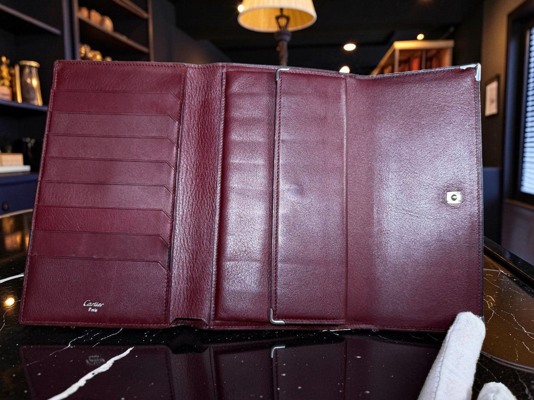 Cartier Cabochon Leather International Flap Wallet (Black with Red Interior).