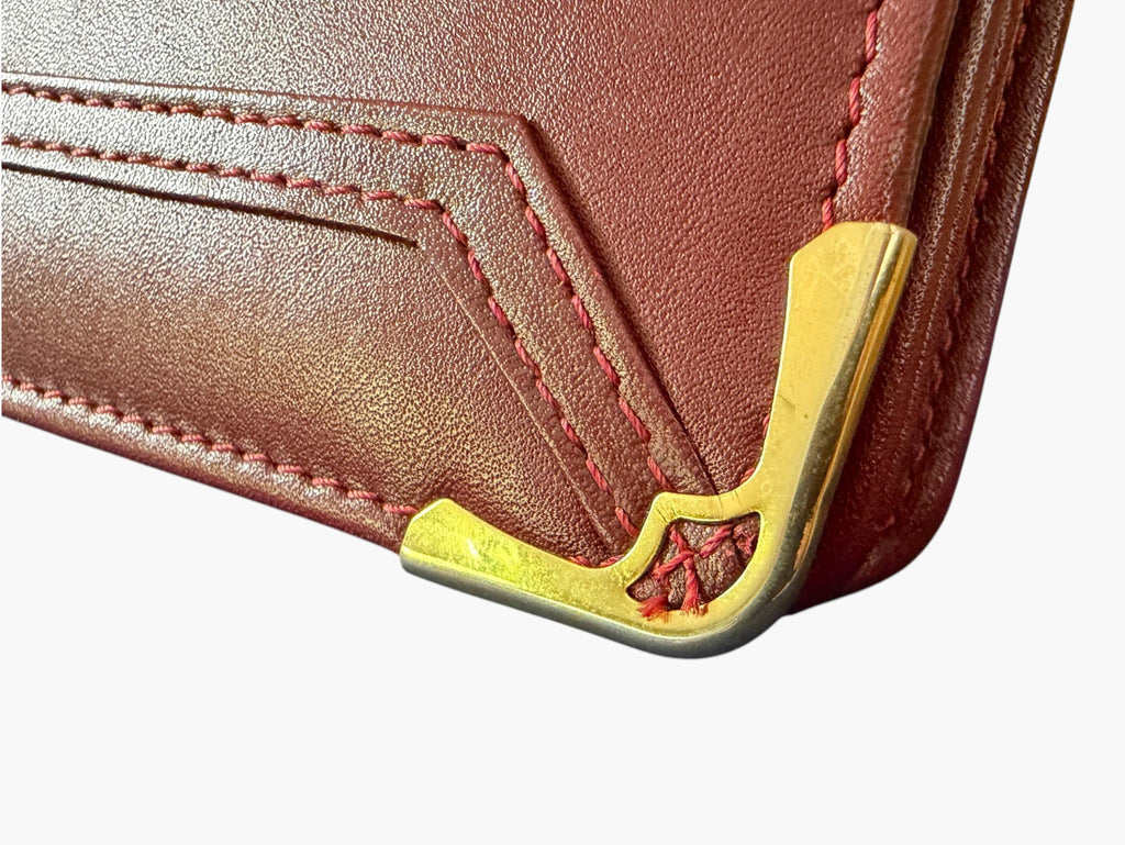 Close-up of gold-tone corner protector on Cartier clutch