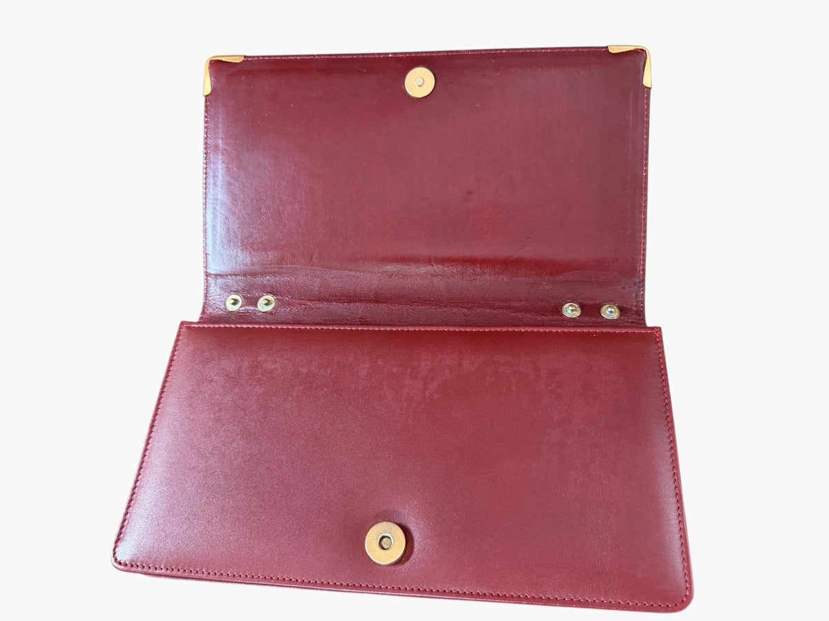 Cartier Must de Cartier clutch open, showing interior and magnetic closure