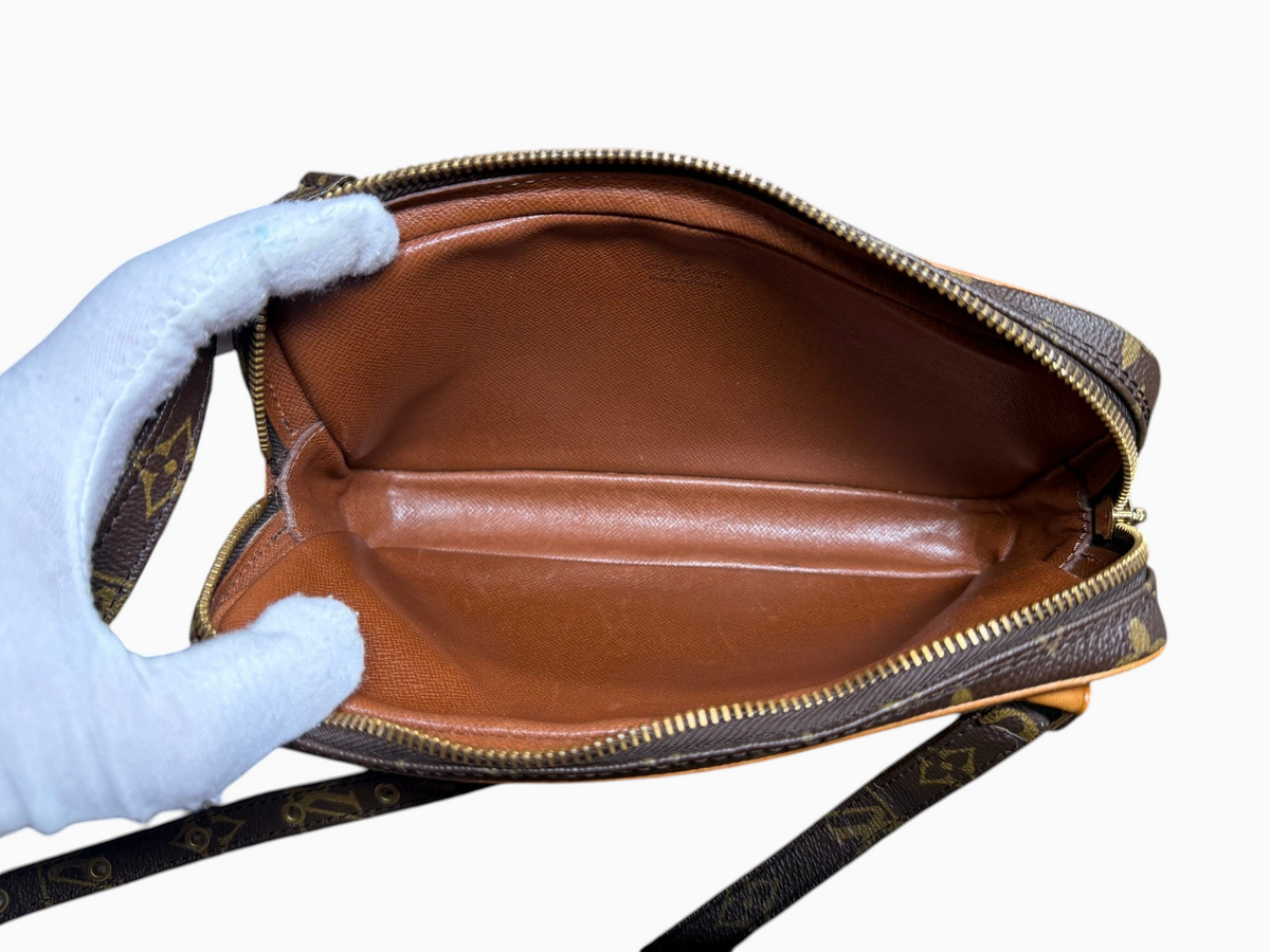 Interior of a vintage newtoyouluxuries Louis Vuitton Pochette Marly bag showing clean brown leather lining